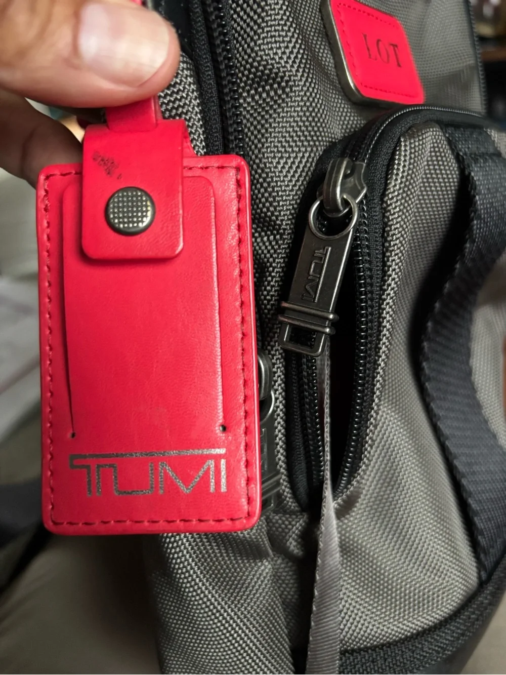 Tumi FIFE Gray SLIM Sling Bag dark grey and black.